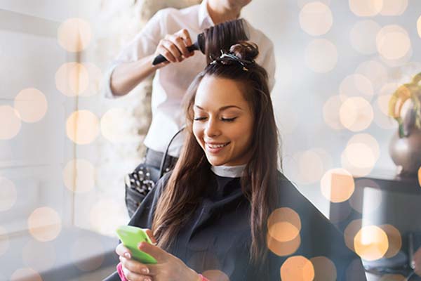 Happy client getting hair styled